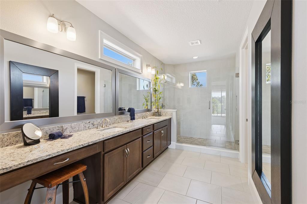 13436 Heswall Run Orlando, FL 32832 - Photo 23 of 72 a bathroom with a granite countertop double vanity sink and a mirror