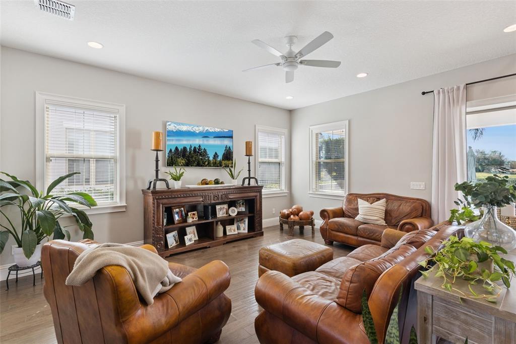 13436 Heswall Run Orlando, FL 32832 - Photo 6 of 72 a living room with furniture a chandelier and a flat screen tv