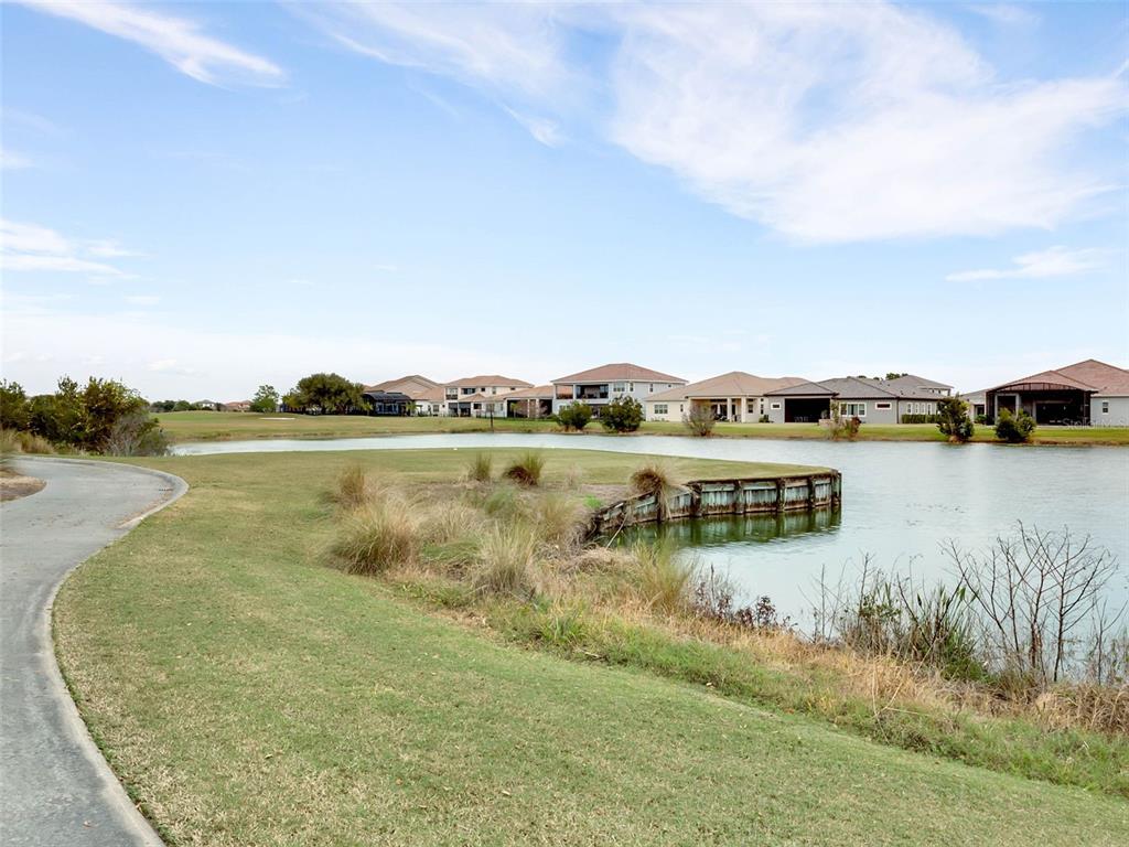 13436 Heswall Run Orlando, FL 32832 - Photo 63 of 72 a view of a lake with houses in the back