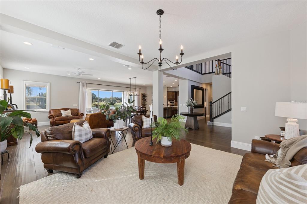 13436 Heswall Run Orlando, FL 32832 - Photo 7 of 72 a living room with furniture and a chandelier