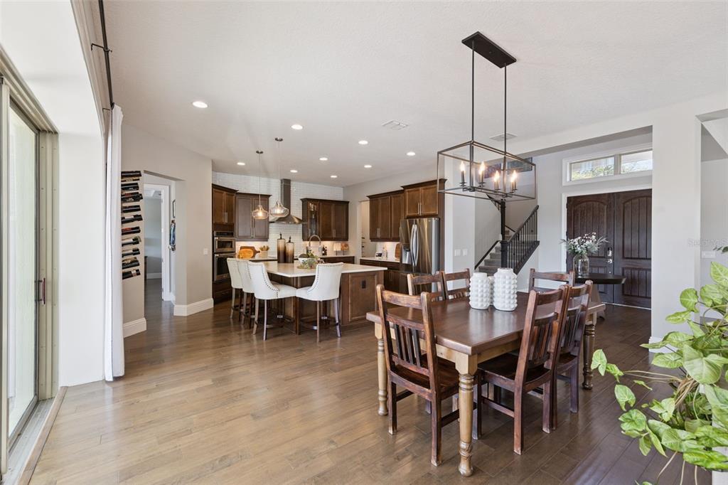 13436 Heswall Run Orlando, FL 32832 - Photo 9 of 72 a view of a dining room and livingroom with furniture wooden floor a chandelier
