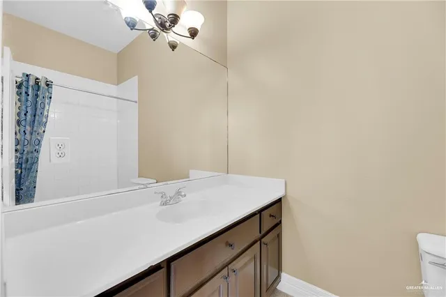 an empty room with wooden floor and ceiling fan