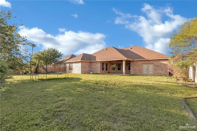 an aerial view of residential house with outdoor space and swimming pool