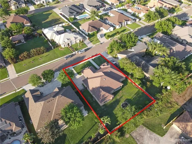 an aerial view of a house with a yard