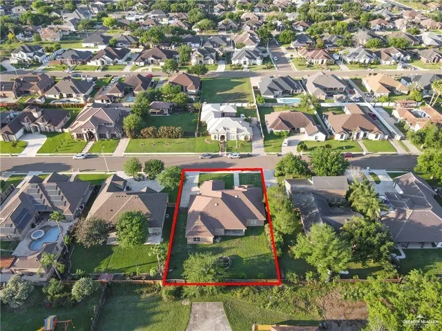 an aerial view of a tennis ground and a residential houses