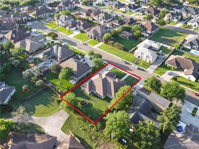 an aerial view of a house with garden space and street view