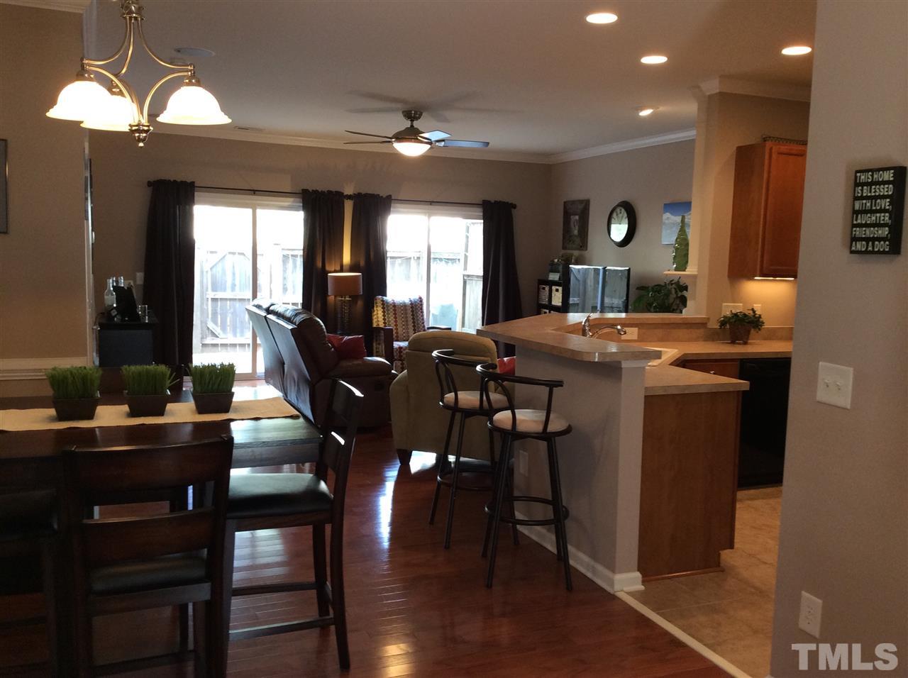 8706 Owl Roost Place Raleigh, NC 27617 - Photo 2 of 7 a view of a dining room with furniture window and wooden floor