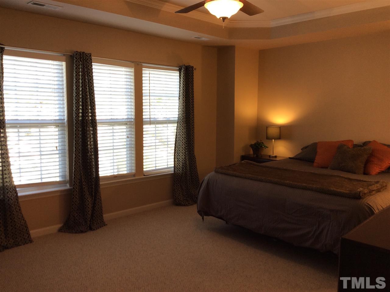 8706 Owl Roost Place Raleigh, NC 27617 - Photo 4 of 7 a bed sitting in a bedroom next to a window