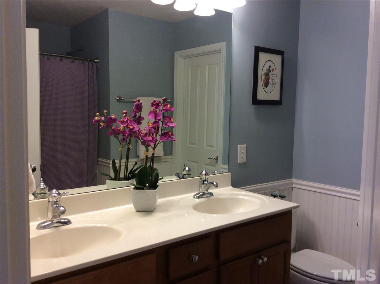8706 Owl Roost Place Raleigh, NC 27617 - Photo 6 of 7 a bathroom with a sink vanity and a mirror