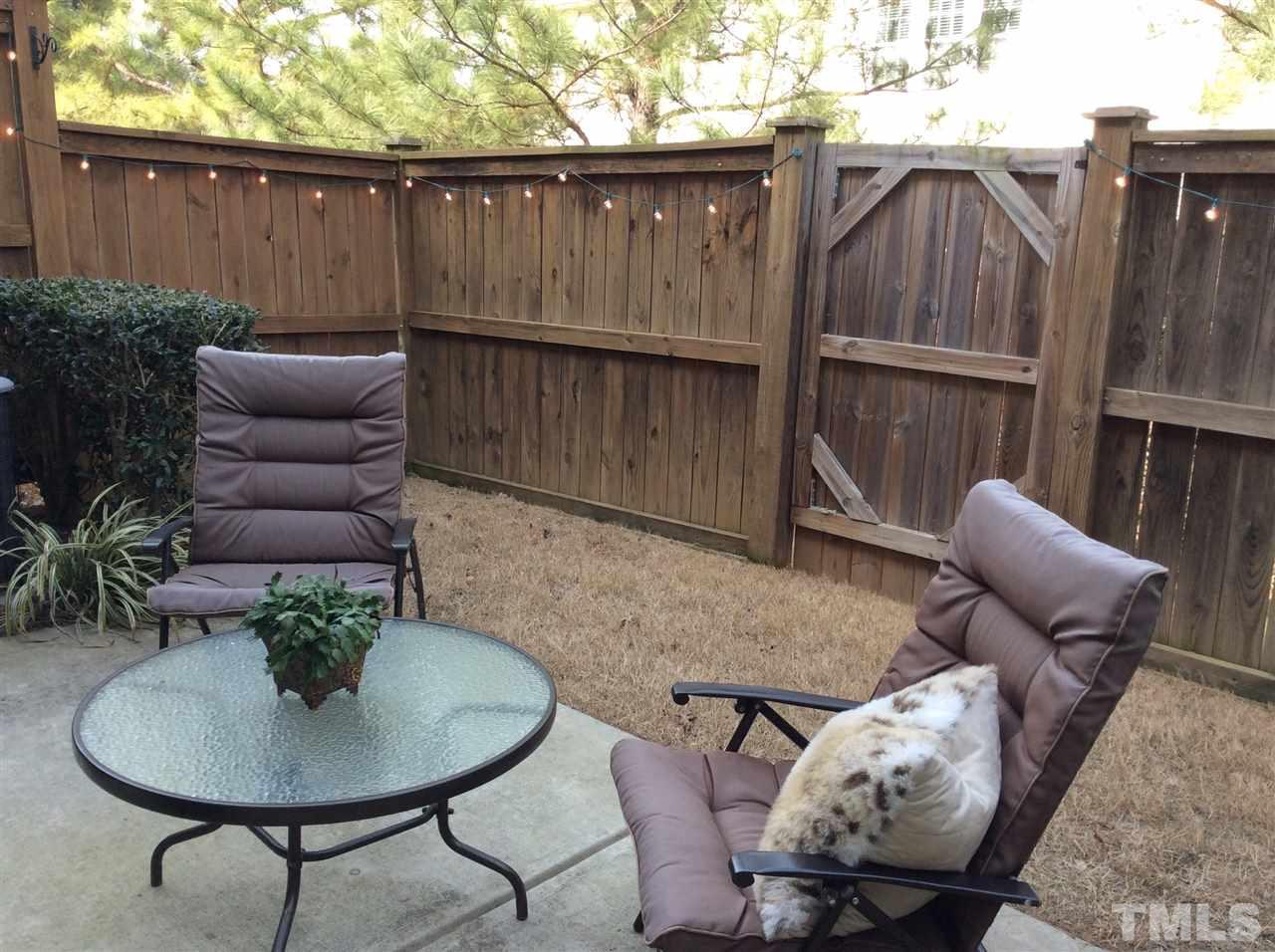 8706 Owl Roost Place Raleigh, NC 27617 - Photo 7 of 7 a backyard of a house with table and chairs