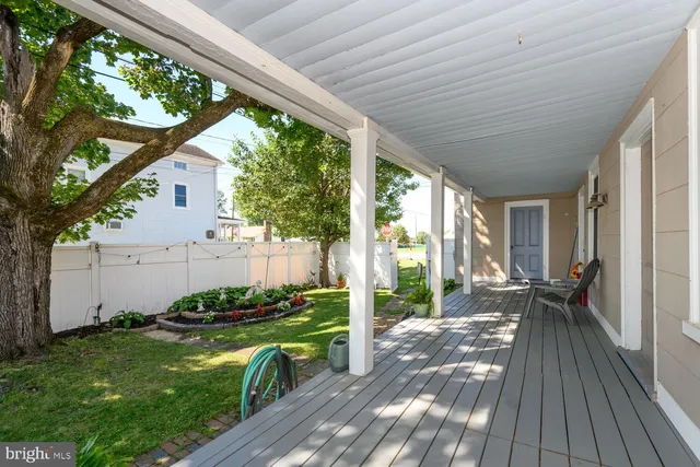 a view of a patio with chair table and chairs