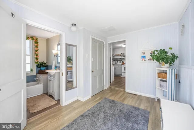 a view of livingroom with hardwood floor and a refrigerator