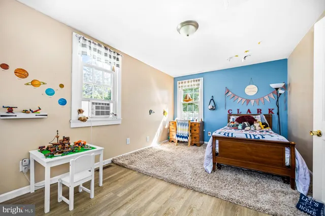 a bedroom with furniture and a window