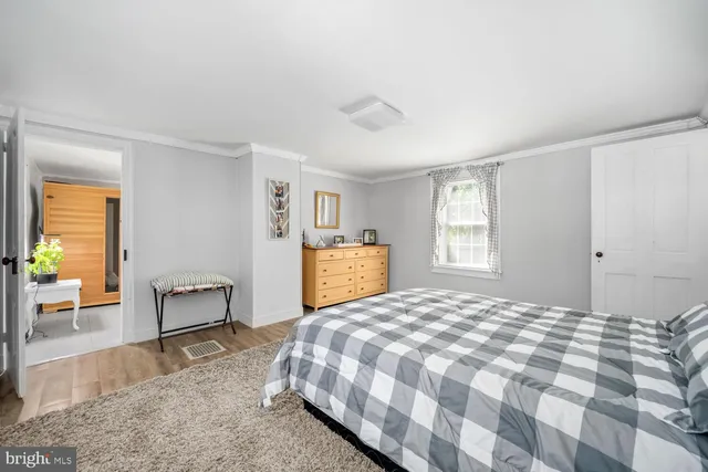 a bedroom with a large bed and a chair