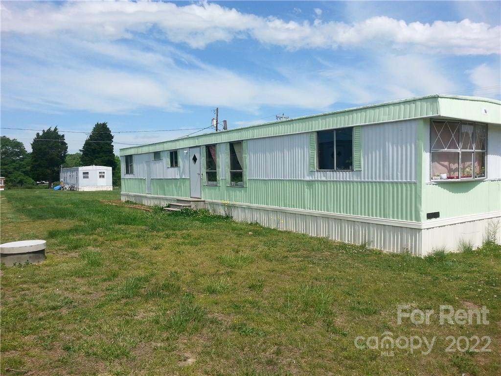 331 Oak Grove Road, Unit 16 Kings Mountain, NC 28086 - Photo 1 of 1 a backyard of a house with table and chairs