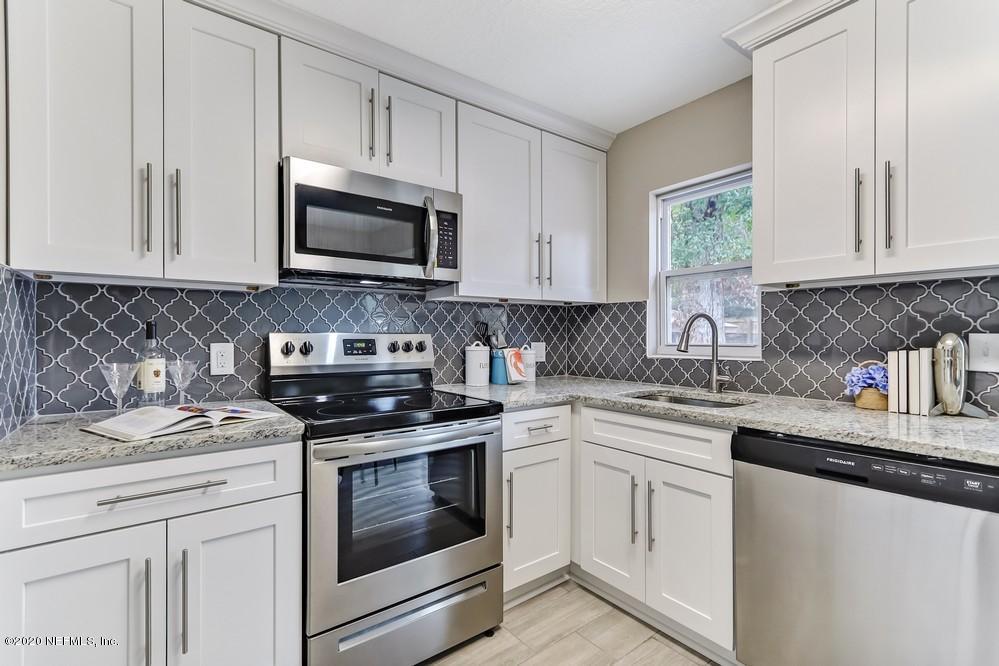 117 Hercules Road St. Augustine, FL 32086 - Photo 11 of 26 a kitchen with stainless steel appliances granite countertop white cabinets sink and stove