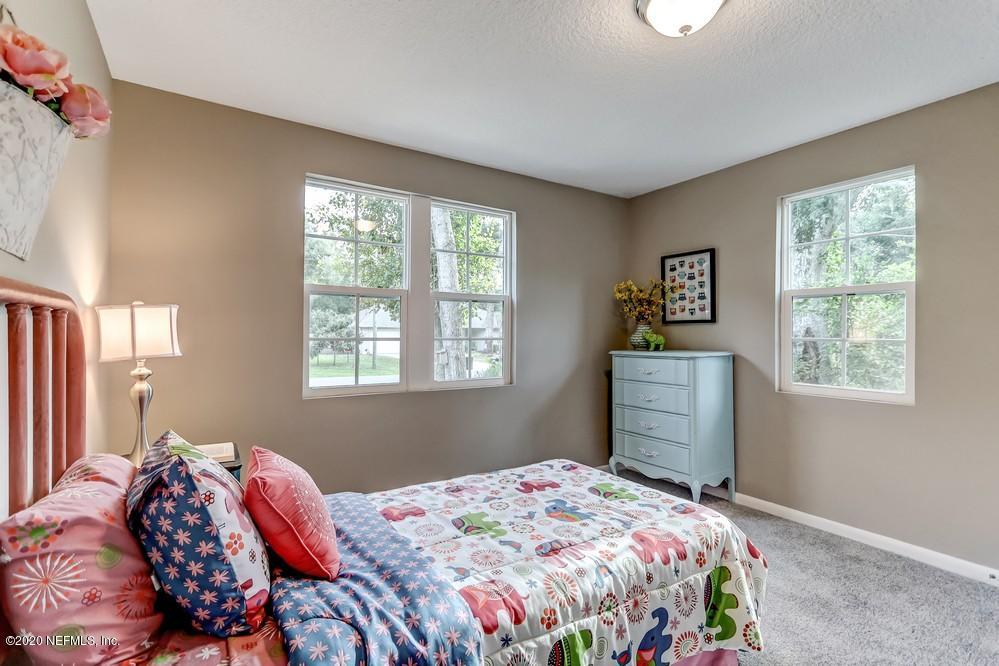 117 Hercules Road St. Augustine, FL 32086 - Photo 14 of 26 a bedroom with a bed and a window