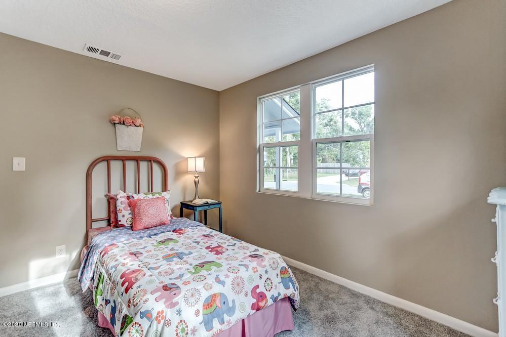 117 Hercules Road St. Augustine, FL 32086 - Photo 15 of 26 a bedroom with a bed and a window
