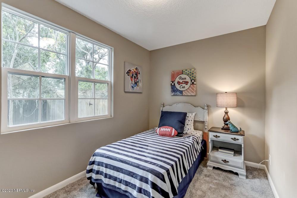 117 Hercules Road St. Augustine, FL 32086 - Photo 17 of 26 a bedroom with a bed and a window
