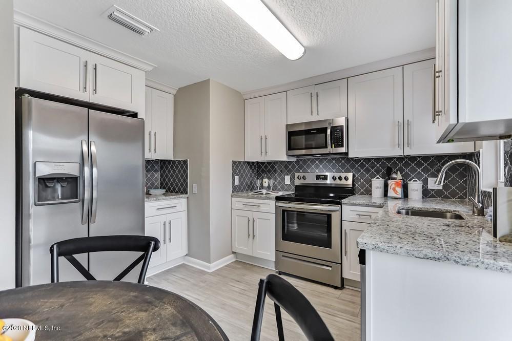 117 Hercules Road St. Augustine, FL 32086 - Photo 2 of 26 a kitchen with stainless steel appliances granite countertop a stove a sink dishwasher and a refrigerator