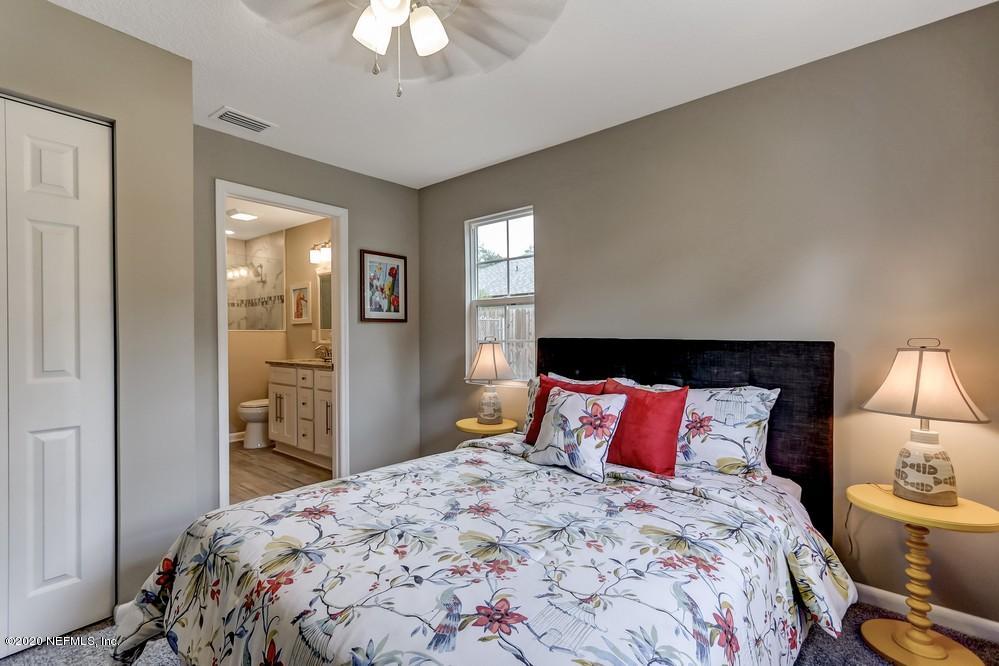 117 Hercules Road St. Augustine, FL 32086 - Photo 4 of 26 a bedroom with a bed and a lamp