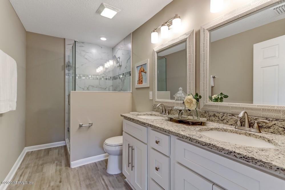 117 Hercules Road St. Augustine, FL 32086 - Photo 5 of 26 a bathroom with a granite countertop sink a toilet and a mirror