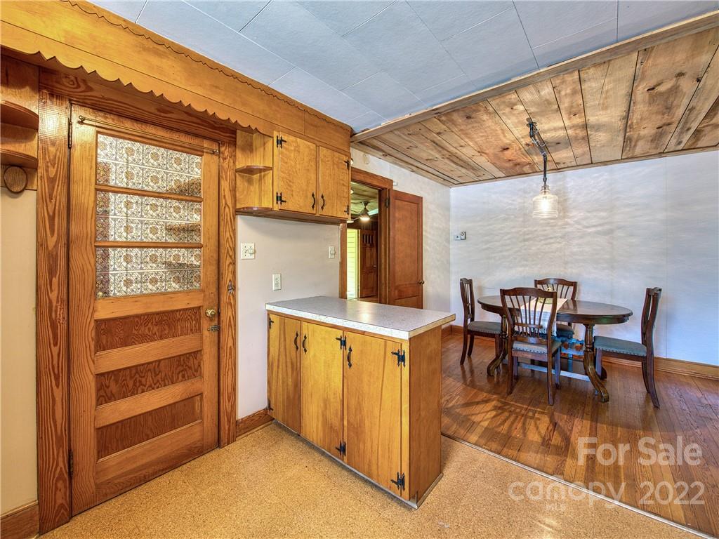 5474 Soco Road Maggie Valley, NC 28751 - Photo 12 of 48 a view of a dining room with furniture window and wooden floor