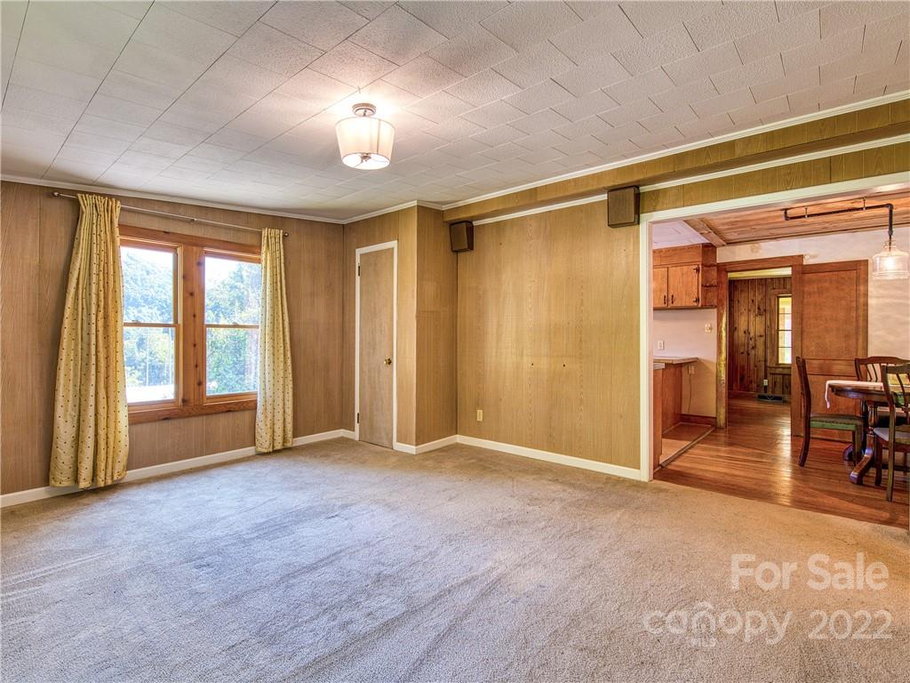 5474 Soco Road Maggie Valley, NC 28751 - Photo 13 of 48 a view of empty room with wooden floor and fan