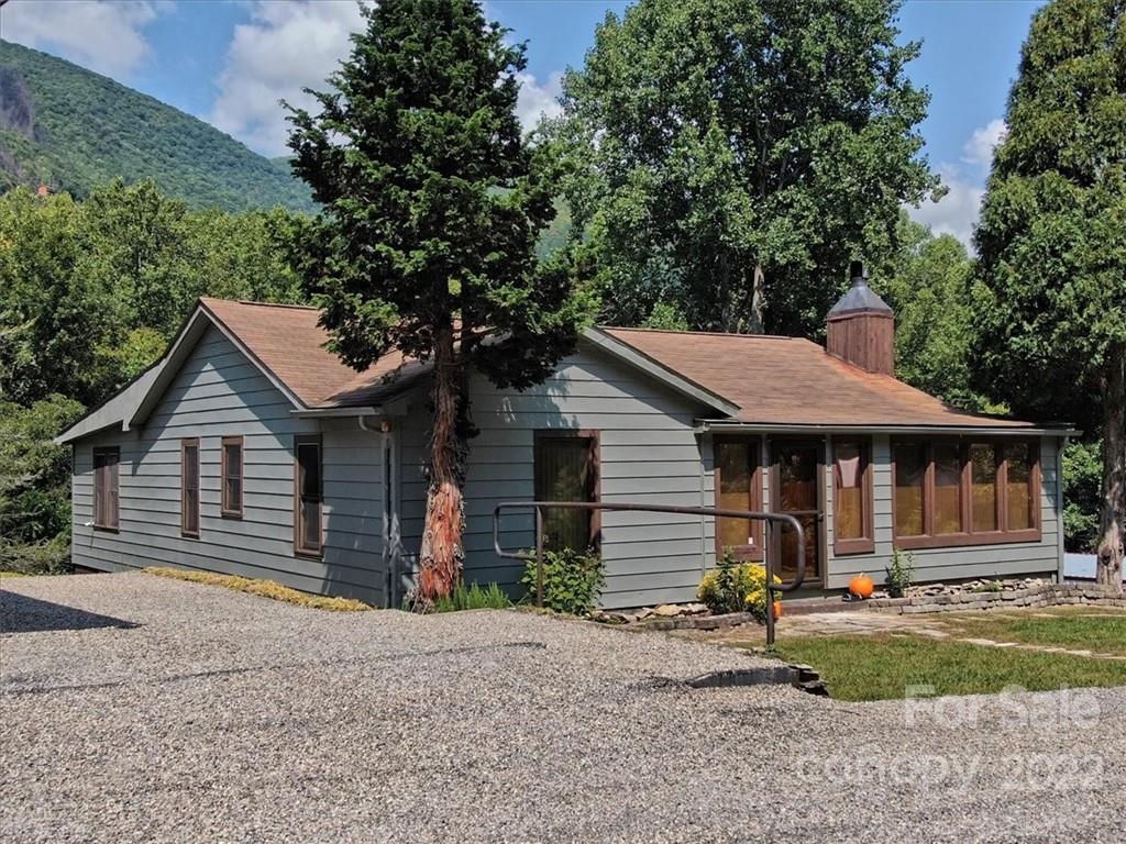 5474 Soco Road Maggie Valley, NC 28751 - Photo 2 of 48 a front view of a house with a yard and garage