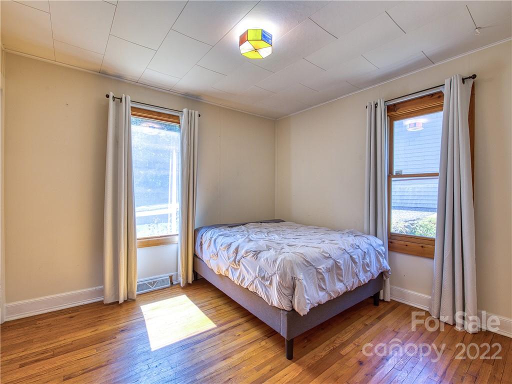 5474 Soco Road Maggie Valley, NC 28751 - Photo 21 of 48 a bedroom with a bed and a window