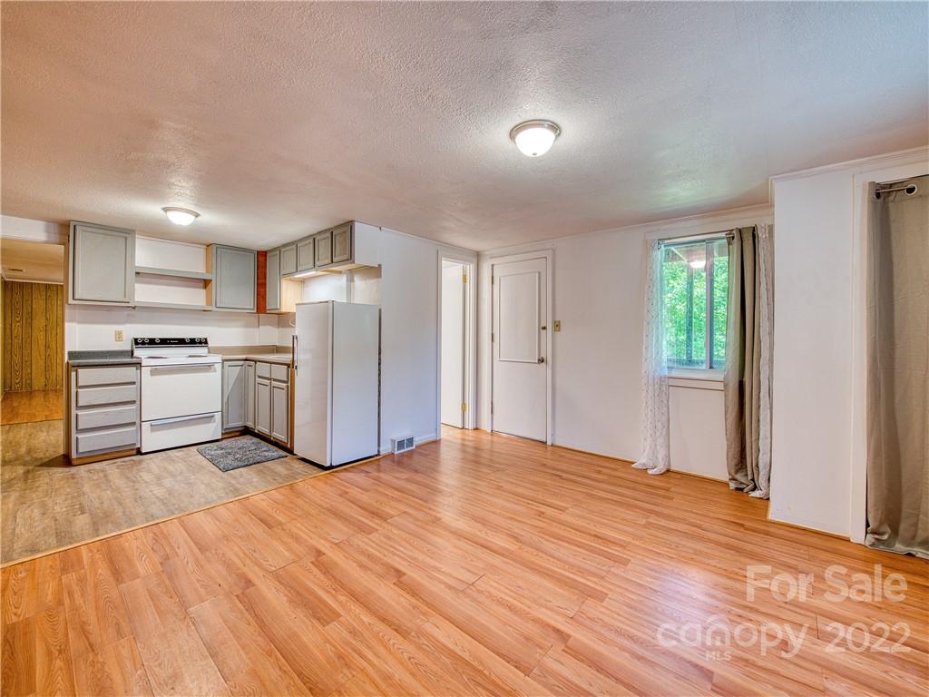 5474 Soco Road Maggie Valley, NC 28751 - Photo 25 of 48 a view of kitchen with wooden floor electronic appliances and window