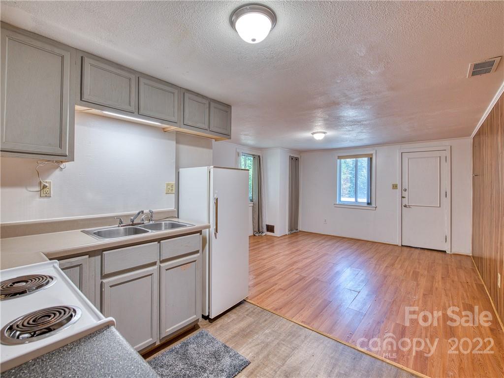 5474 Soco Road Maggie Valley, NC 28751 - Photo 26 of 48 a kitchen with granite countertop a refrigerator stove and sink