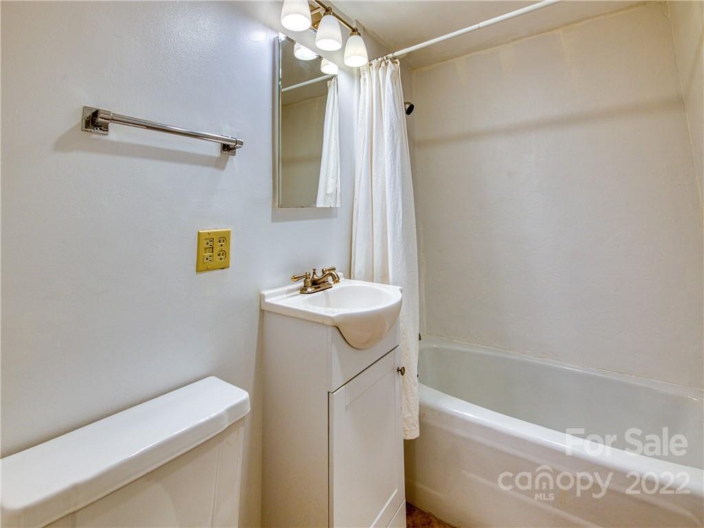 5474 Soco Road Maggie Valley, NC 28751 - Photo 28 of 48 a bathroom with a sink a bathtub and a shower