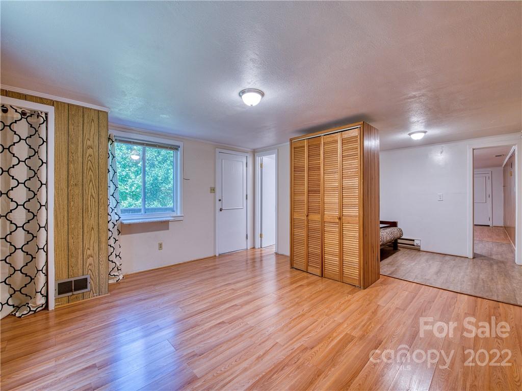 5474 Soco Road Maggie Valley, NC 28751 - Photo 29 of 48 an empty room with wooden floor and windows