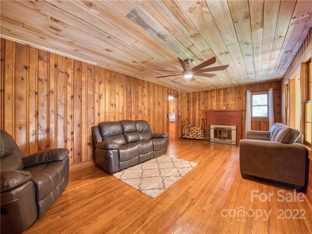 5474 Soco Road Maggie Valley, NC 28751 - Photo 6 of 48 a living room with furniture and a chandelier
