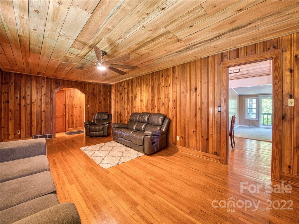 5474 Soco Road Maggie Valley, NC 28751 - Photo 8 of 48 a spacious bedroom with a bed and glass door