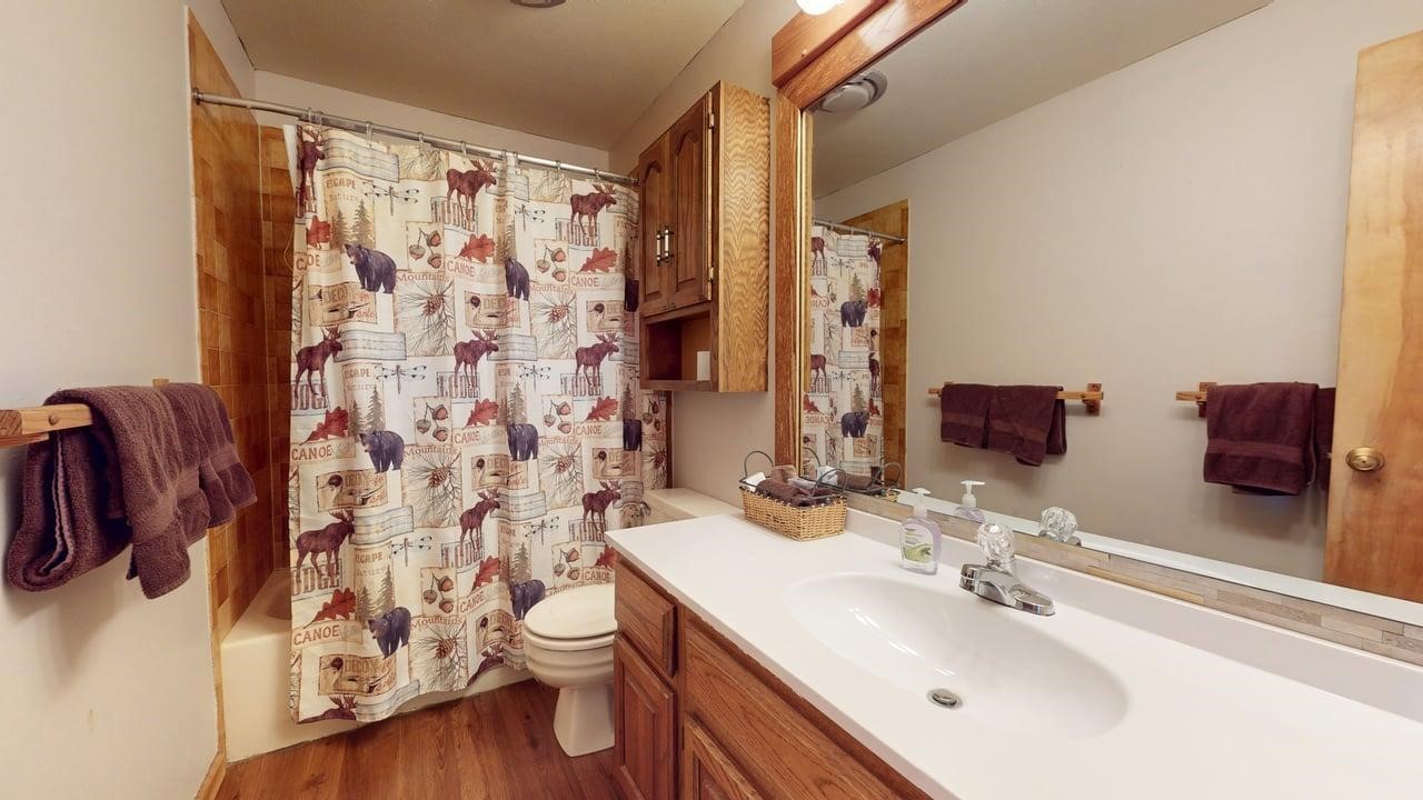 91200 Ryan Gulch Road, Unit 213 Silverthorne, CO 80498 - Photo 25 of 33 a bathroom with a sink and a mirror