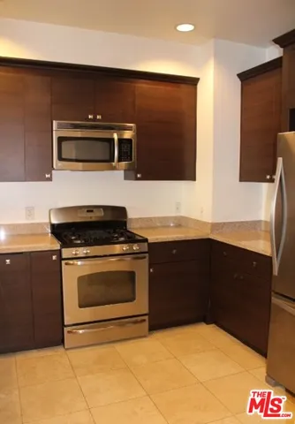 a kitchen with stainless steel appliances a sink and a stove