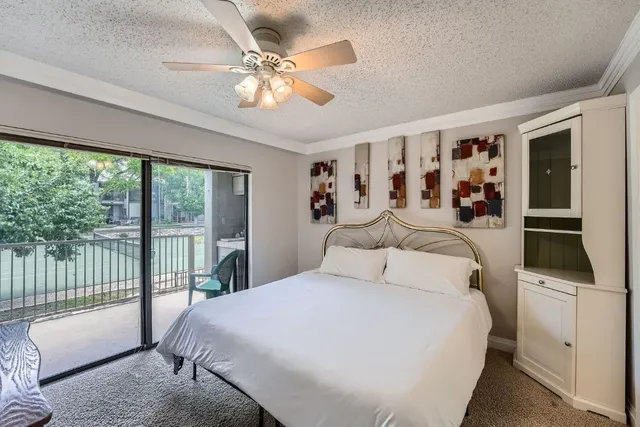a bedroom with a large bed and a chandelier