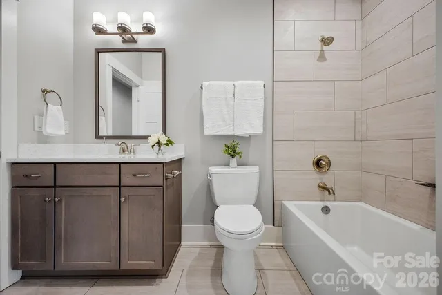 a bathroom with a sink a potted plant and a mirror