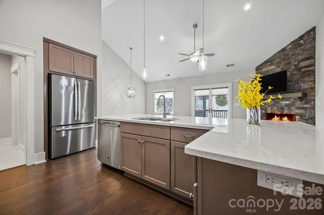 a kitchen with stainless steel appliances a sink stove and refrigerator