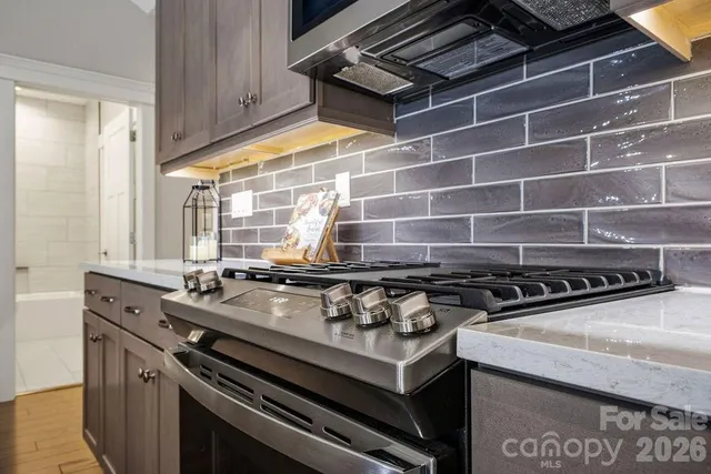 a stove top oven sitting inside of a kitchen