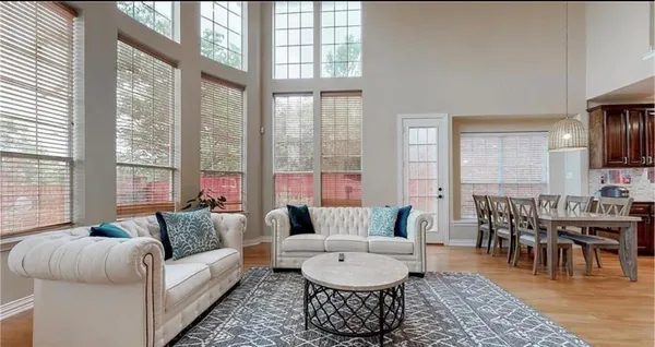 a living room with furniture and a large window