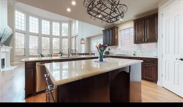 a kitchen with a counter space a sink and a window