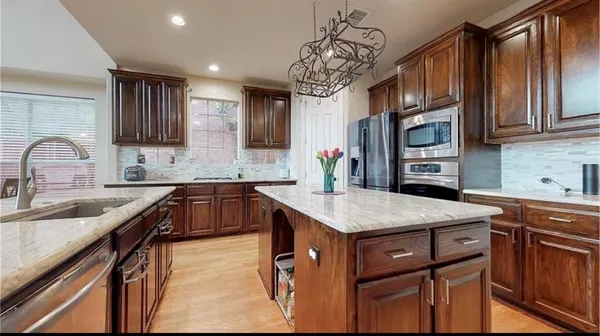 a kitchen with a sink stove and cabinets