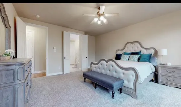 a bed room with a bed and a chandelier
