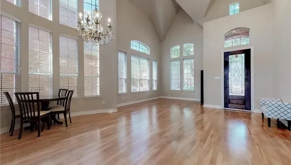 a view of a dining room with furniture and wooden floor