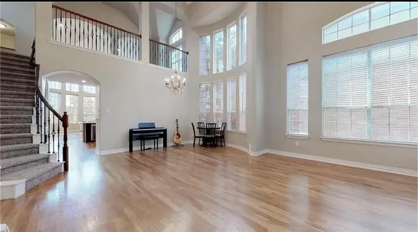 a view of a livingroom with furniture and staircase