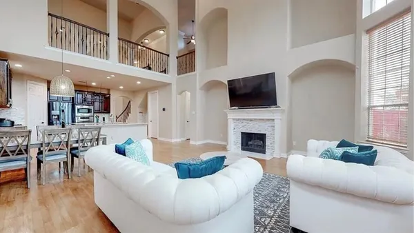 a living room with furniture a fireplace and a flat screen tv
