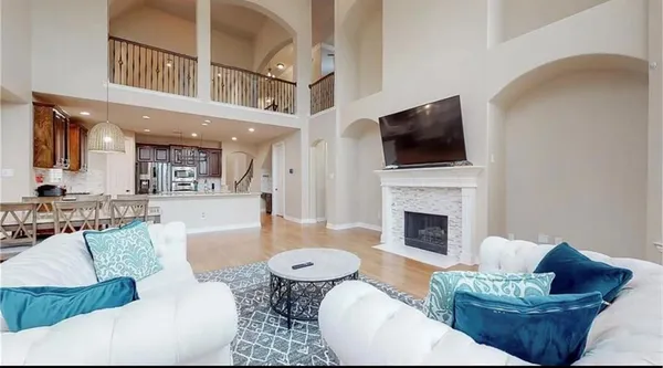 a living room with furniture a fireplace and a flat screen tv